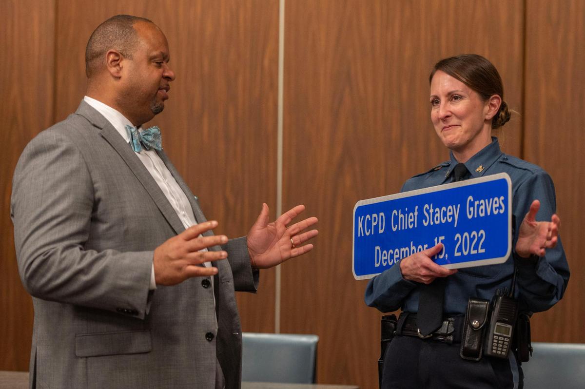Public works director Michael J. Shaw, left, presented Kansas City Police Chief Stacey Graves a street-like sign after a meeting of the South Kansas City Alliance at the South Patrol Police Campus earlier this month. The sign features the date Graves was named chief.