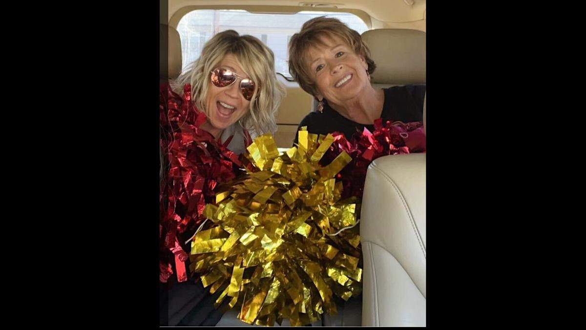Kendra Manley, 51, and her mother Cindy Rose, 73, smile for a photo on their way to a halftime practice.