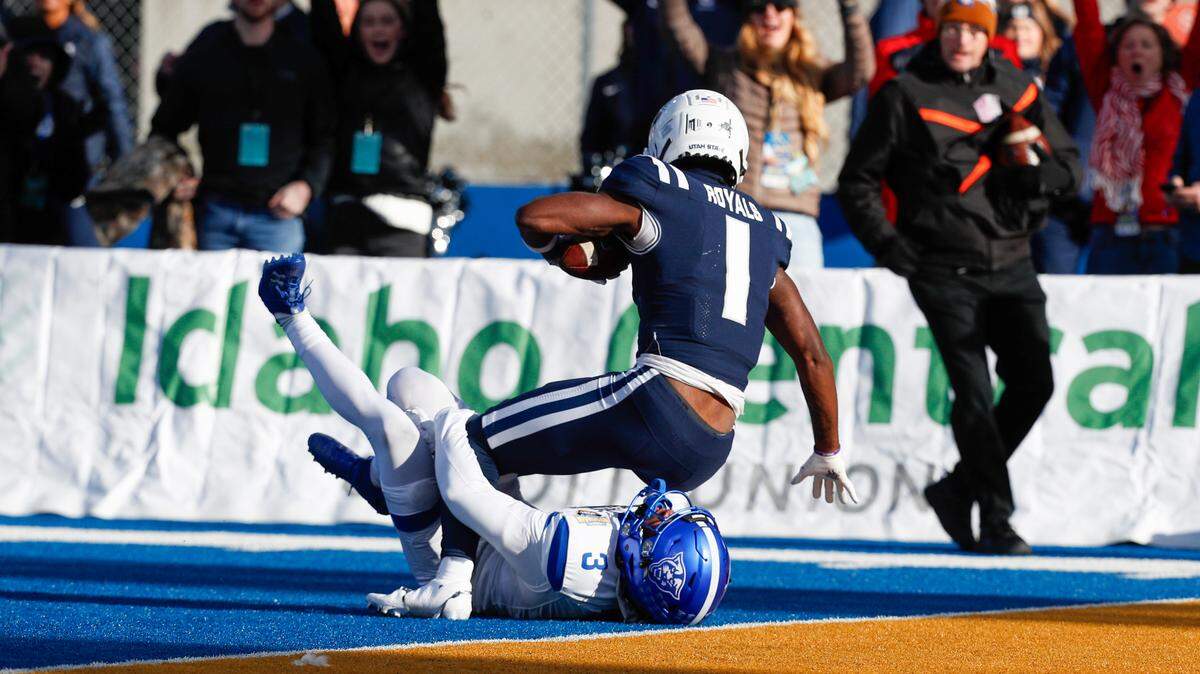 Utah State Aggies wide receiver Jalen Royals (1) scores a touchdown during the first half against the Georgia State Panthers at Albertsons Stadium in 2023.