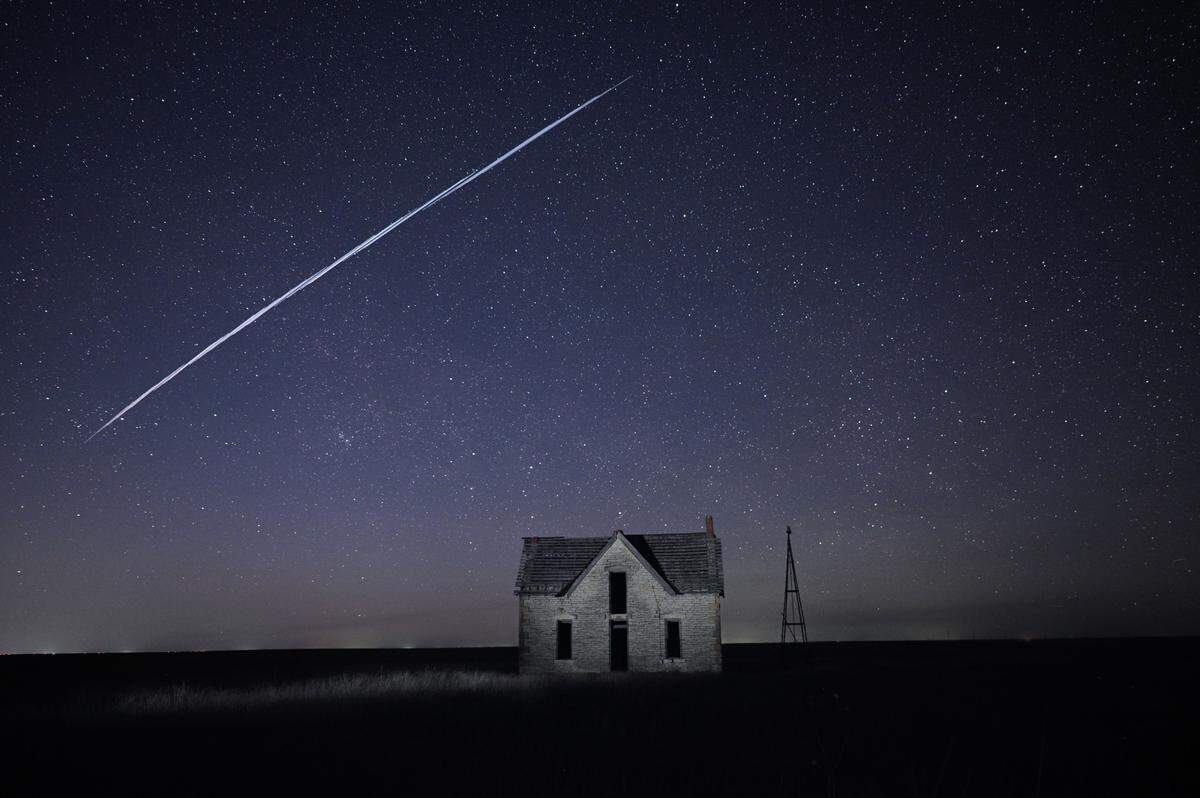 Plenty of Kansans thought they were seeing UFOs last month, but it was actually SpaceX Starlink satellites that had recently launched in Florida. Here they pass over an old stone house near Cottonwood Falls.