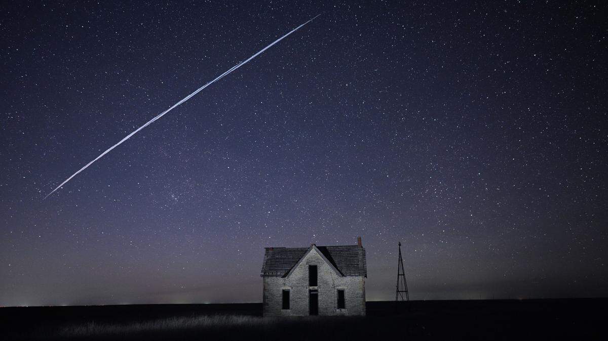 SpaceX Starlink satellites pass over an old stone house near Cottonwood Falls, Kansas, Thursday night. Sixty of the satellites were launched on Tuesday from The Kennedy Space Center in Florida.