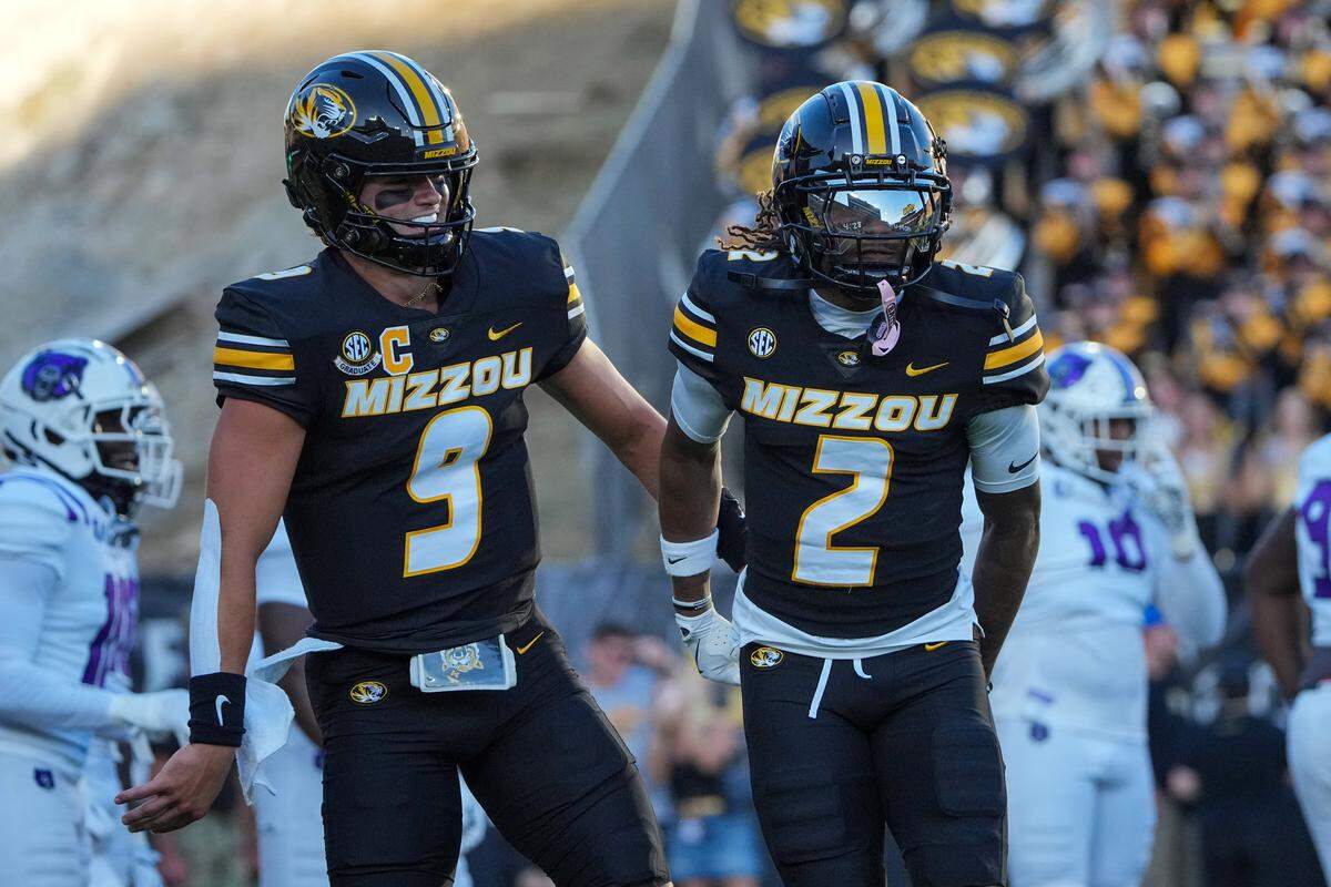 Missouri Tigers wide receiver Marquis Johnson (2) celebrates with quarterback Beau Pribula (9) after scoring against the Central Arkansas Bears during the first half of the game at Faurot Field at Memorial Stadium on Aug. 28, 2025.