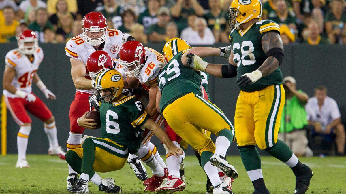 Green Bay Packers quarterback Graham Harrell is hit during a play by Kansas City Chiefs linebacker Andy Studebaker (96), defensive end Brandon Bair (90) and strong safety Donald Washington (27) during an NFL pre season football game Thursday, Aug. 30, 2012, in Green Bay, Wis. (AP Photo/Matt Ludtke)