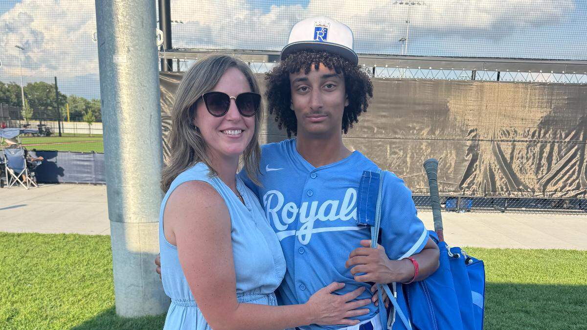 Treyton Hartsook is seen in his Team KC baseball uniform with his mom Amber Hartsook.