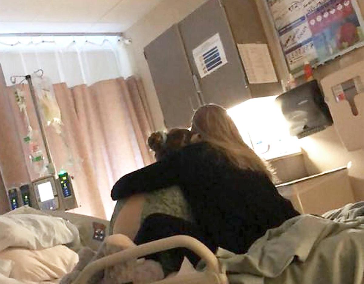 In the hospital, Kendyll Walker comforts her daughter Jordyn. “You need to look at this kid,” she told the medical staff. “She needs to go to the ICU.”