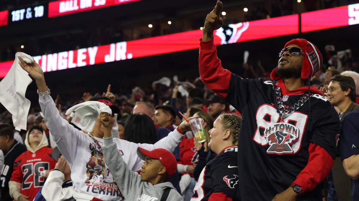 Houston Texans fans react during the fourth quarter against the Los Angeles Chargers in an AFC wild card game at NRG Stadium.