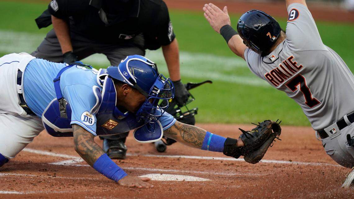 Detroit Tigers Austin Romine (7) misses the plate while sliding against Kansas City Royals catcher Salvador Perez, left, during the first inning of a baseball game at Kauffman Stadium in Kansas City, Mo., Saturday, Sept. 26, 2020. Romine was then tagged out by Perez. (AP Photo/Orlin Wagner)