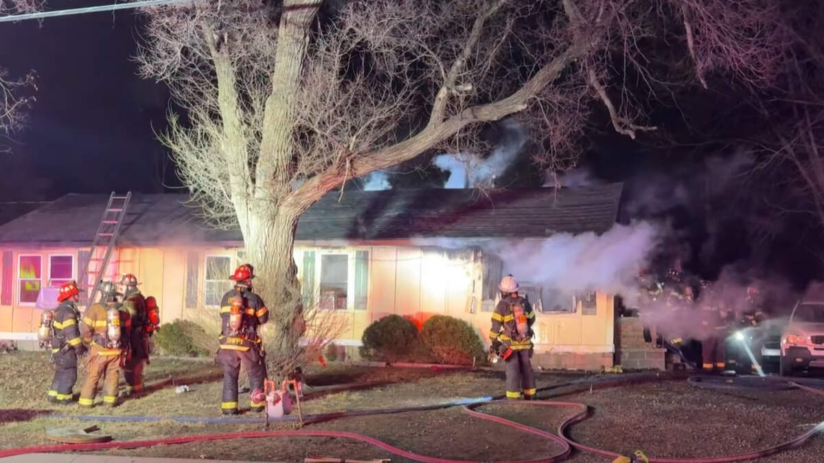 Firefighters with the Olathe Fire Department battle a blaze at a duplex near E. Cothrell Street and N. Walker Lane around 10 p.m. Friday, Feb. 20, 2026. Four people were displaced as the home was left unlivable.