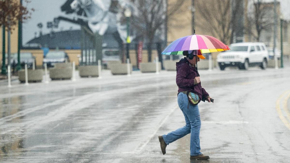 A pedestrian crosses Broadway Boulevard as rain falls on Thursday, March 7, 2024, in Kansas City. Severe thunderstorms are forecasted for Wednesday evening.