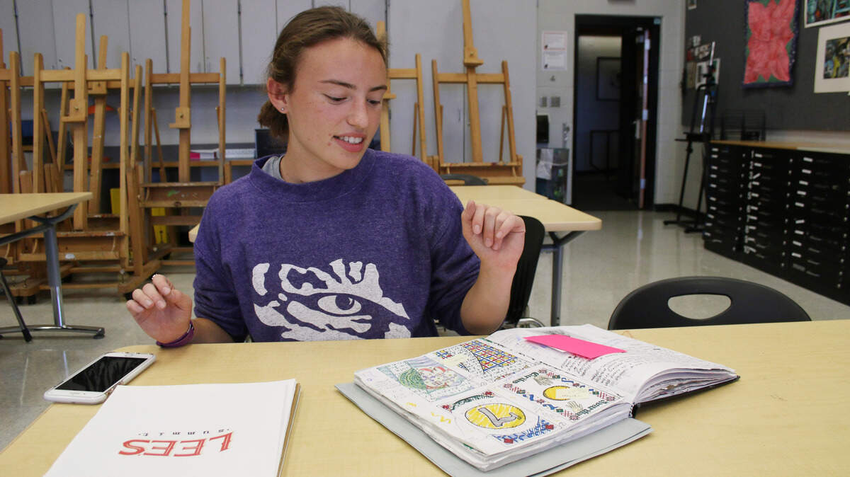 Annie McCord, a senior at Lee’s Summit North, has a sketchbook full of her different text-based designs and different types of calligraphy. 