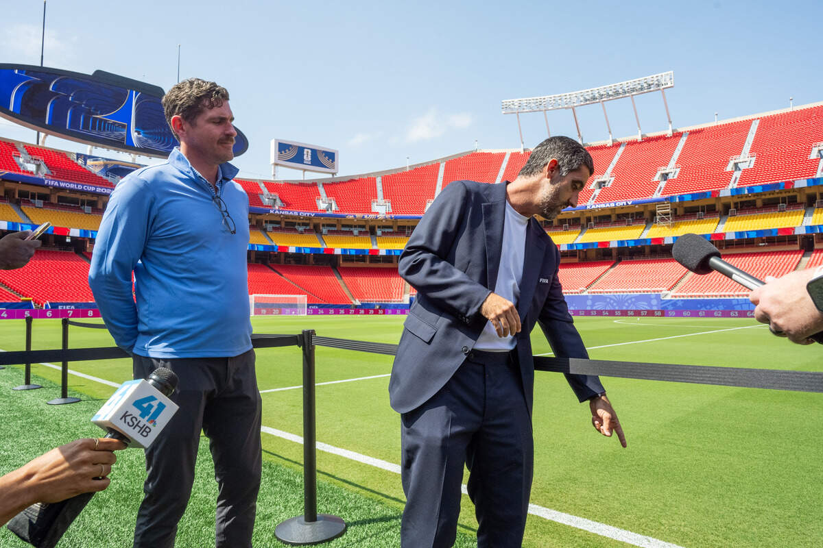 Luiz Mello, Venue Operations Manager for FIFA, points to the pitch at Kansas City Stadium, on Monday, June 8, 2026. The grass was brought in from North Carolina and stitched together months in advance to become acclimated to the weather in Kansas City.