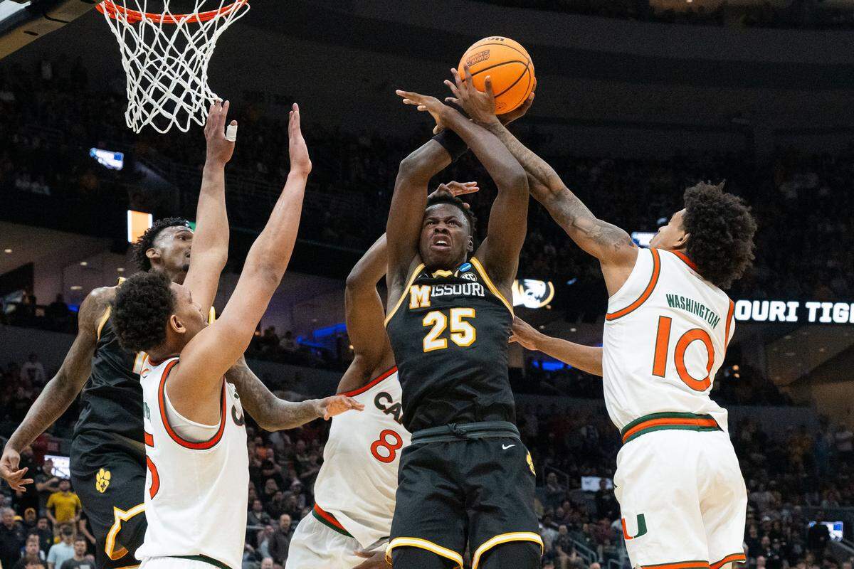 Missouri Tigers forward Mark Mitchell (25) is well defended by Miami Hurricanes defenders in the second half of the Tigers first-round NCAA Tournament matchup vs. the Miami Hurricanes at Enterprise Center in St. Louis on Friday, March 20, 2026.