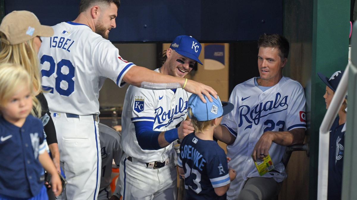 Kansas City Royals outfielder Kyle Isbel and shortstop Bobby Witt Jr. talk to former Royals pitcher Zack Greinke, who had his family with him to see him throw out the ceremonial first pitch before Game 4 of the American League Division Series on Thursday, Oct. 10, 2024, at Kauffman Stadium.