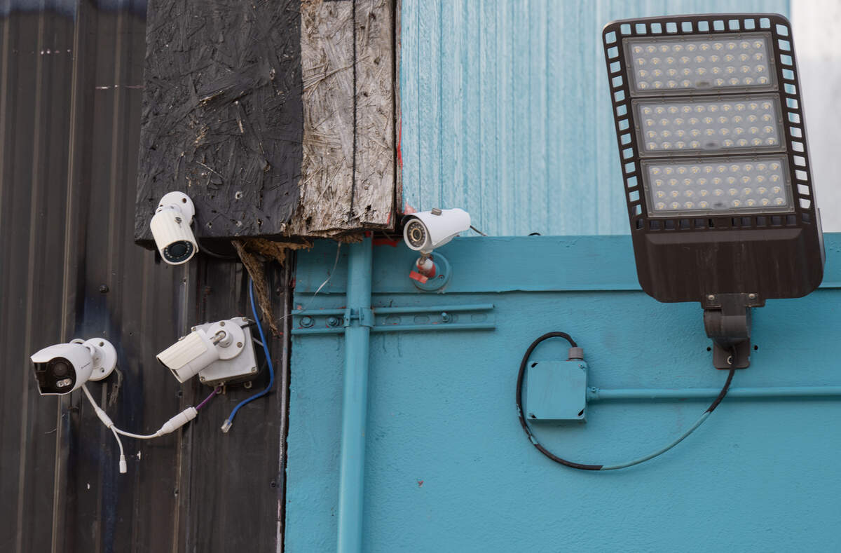 Security cameras and lights are mounted above an entrance at Status nightclub and seen on Monday, Feb. 16, 2026, one day after a shooting left two women dead, at 2801 Southwest Blvd.