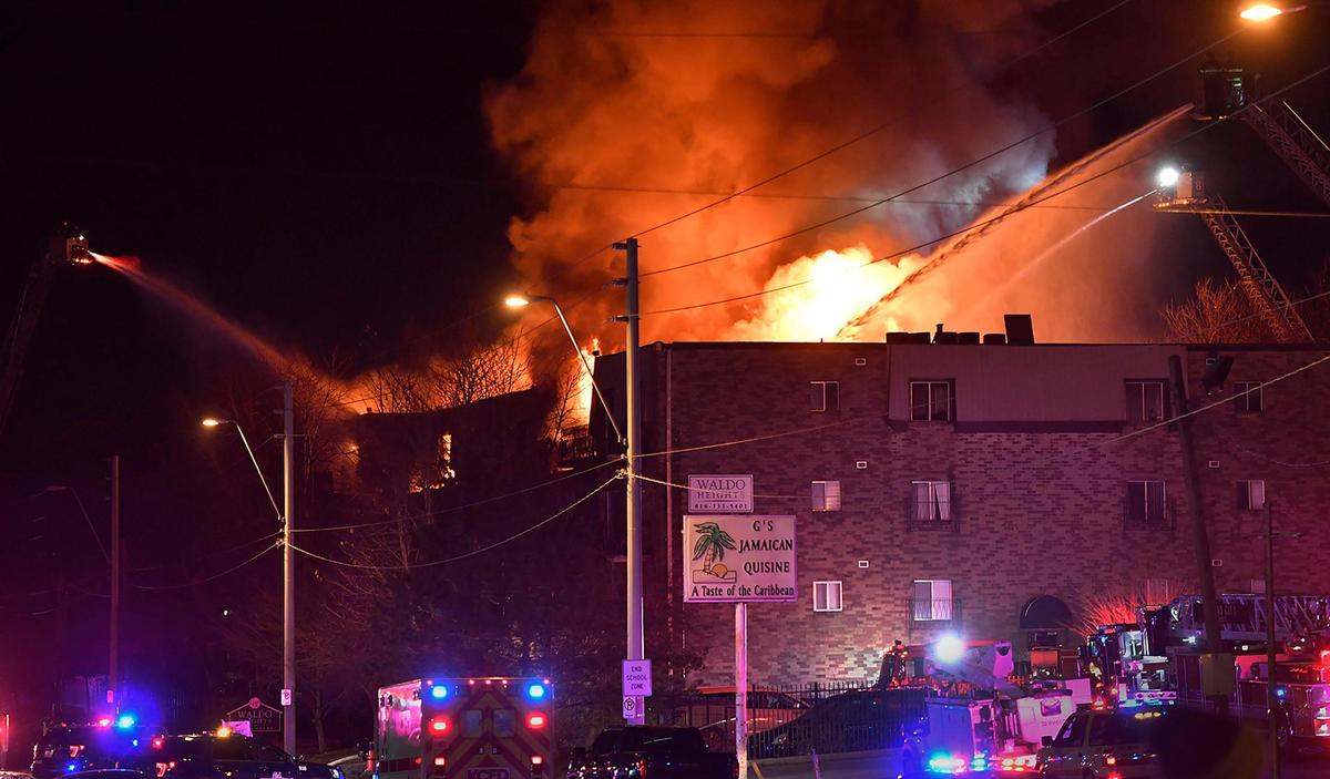 Kansas City firefighters pour water onto a burning apartment building that was engulfed in flames Monday night at 80th Street and Troost Avenue in Kansas City.
