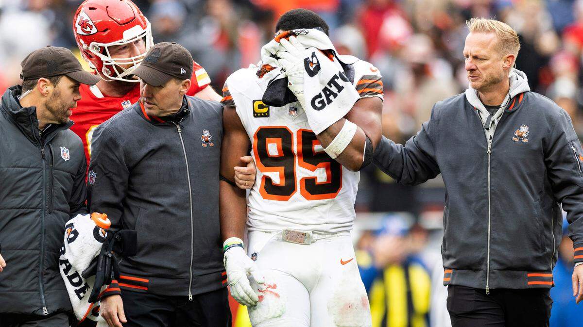 Cleveland Browns defensive end Myles Garrett (95) holds a towel over his face as he is escorted to the locker room following an injury during the second quarter against the Kansas City Chiefs at Huntington Bank Field.