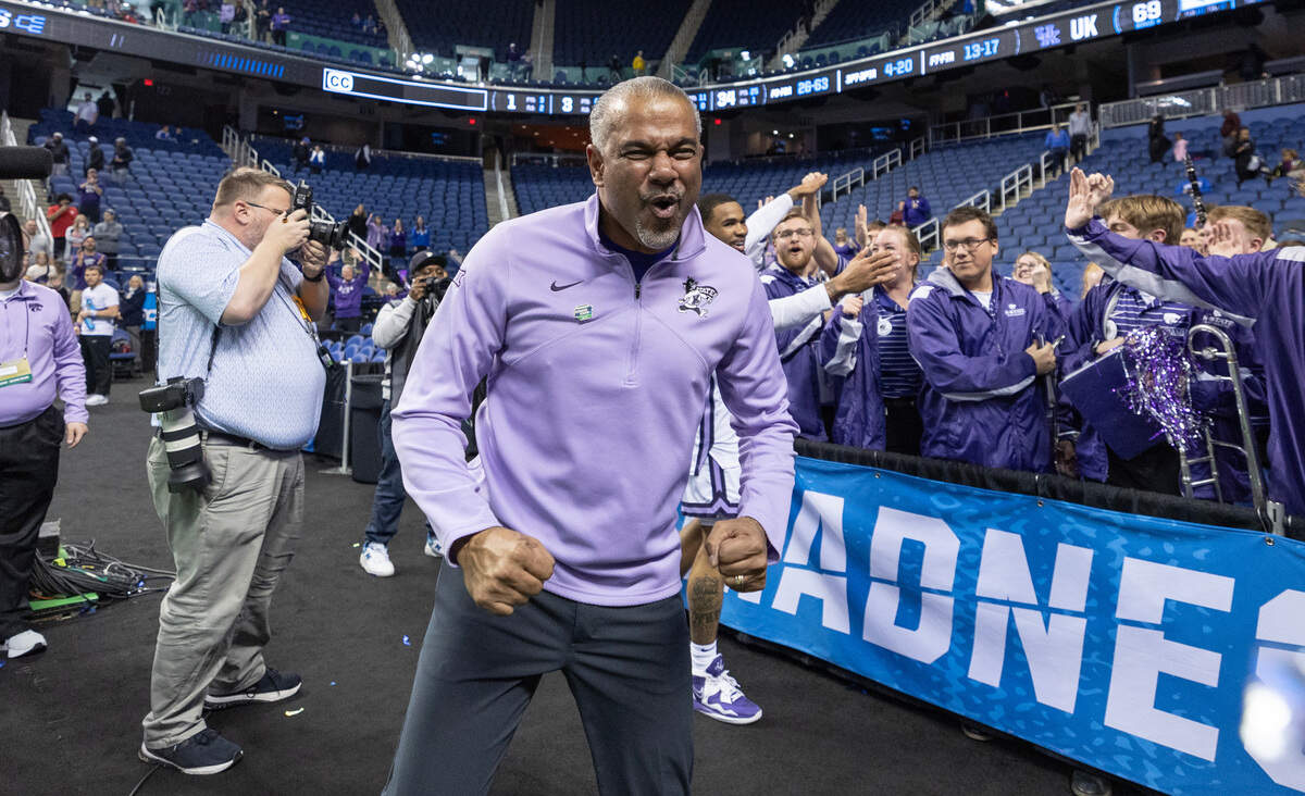 Kansas State Coach Jerome Tang celebrates with the team’s cheerleaders after his team secured a spot in the Sweet 16 with a win over Kentucky in Greensboro, N.C., on Sunday. KSU was picked to finish last in the Big 12 in the preseason.