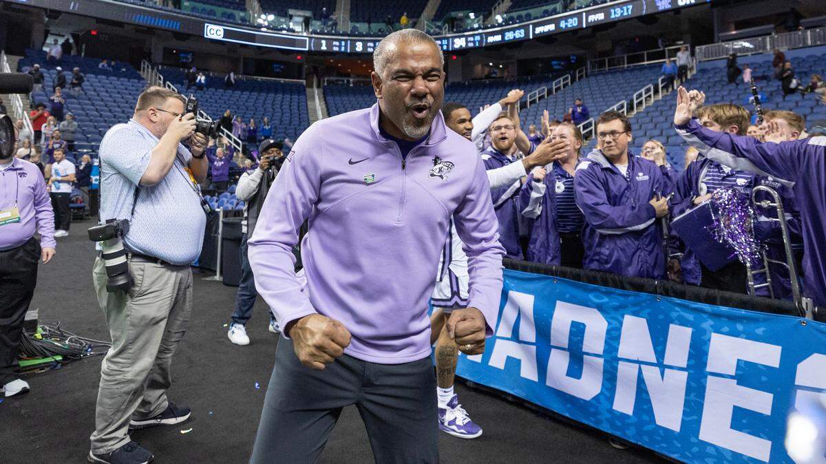 Kansas State coach Jerome Tang celebrates with the team’s cheerleaders after his team secured a spot in the Sweet 16 with a win over Kentucky in Greensboro, NC on Sunday.