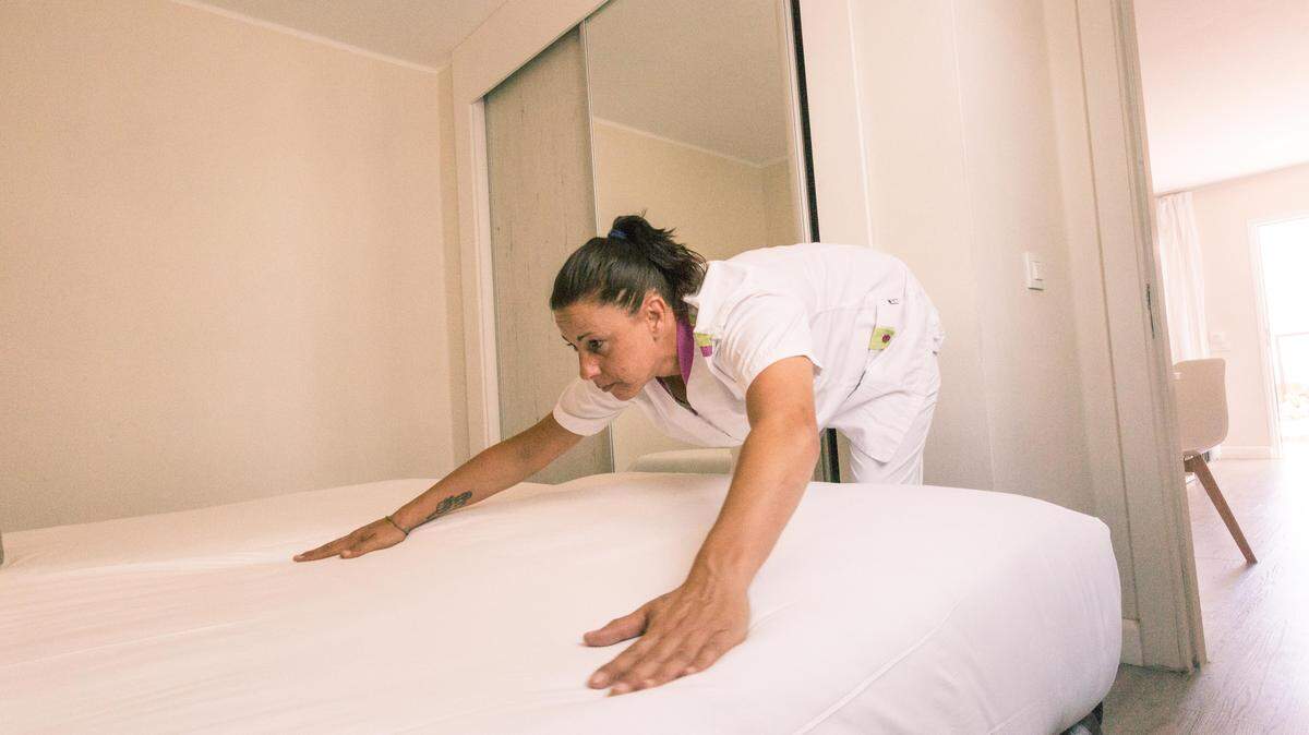 A woman cleaning her bedroom.