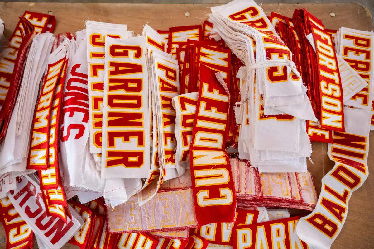 Name tags from the back of game jerseys on display at The Pavilion at GEHA Field at Arrowhead Stadium on Friday, February 20, 2026. Fans can come and shop on Saturday for items such as game worn jerseys, practice gear, and cleats.