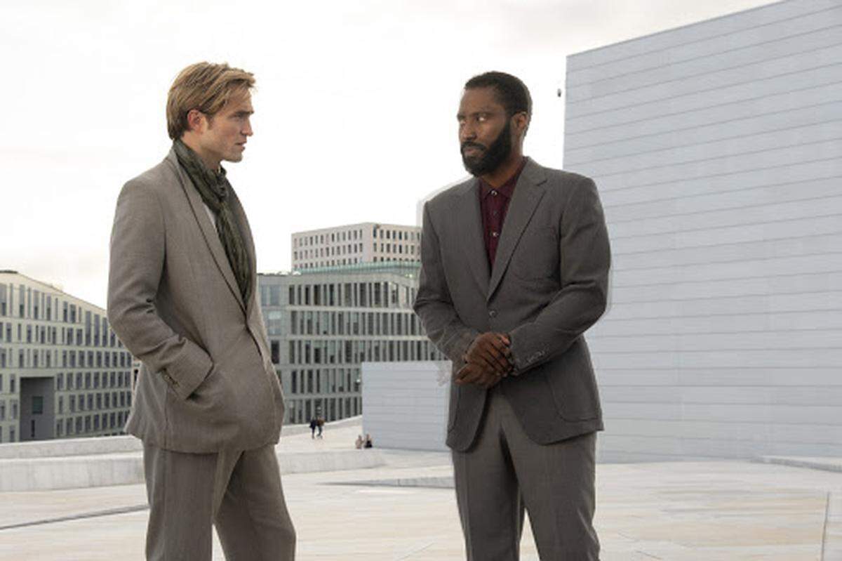 In “Tenet,” Robert Pattinson, left, and John David Washington must bend time to prevent World War III.