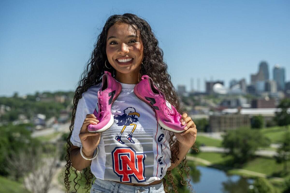 Scholar-Athlete Award recipient Avani Hocker Singh poses for a portrait with her track spikes draped around her neck on Monday, June 15, 2026, in Kansas City.