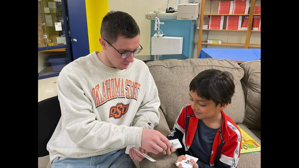 Hunter Simoncic, 26, helps a student at Banneker Elementary in the Lead to Read KC program.