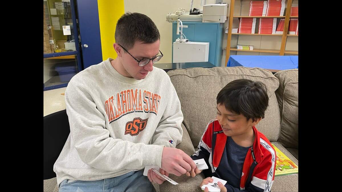 Hunter Simoncic, 26, helps a student at Banneker Elementary in the Lead to Read KC program.