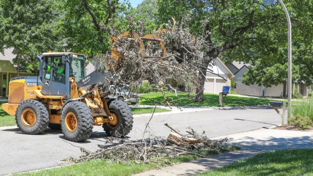 Lenexa Municipal Services Department crews haul storm debris from residential curbsides following strong wind and heavy rain in July of 2023.