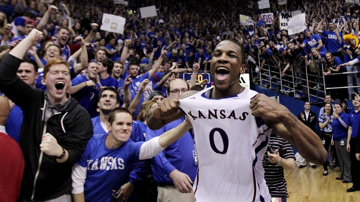 KU basketball great Thomas Robinson poses in front of fans at Allen Fieldhouse in Lawrence.