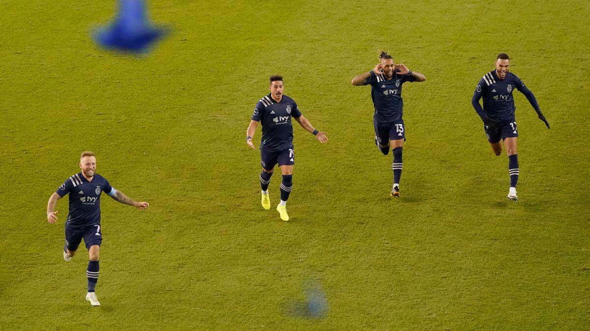 Sporting Kansas City players celebrate after winning an MLS soccer match against the San Jose Earthquakes with a penalty kick in overtime Sunday, Nov. 22, 2020, in Kansas City, Kan. (AP Photo/Charlie Riedel)