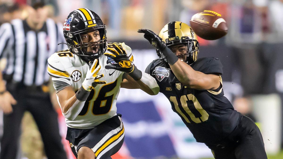 Missouri Tigers wide receiver Tauskie Dove attempts a catch over the outstretched arms of Army cornerback Cameron Jones during the Lockheed Martin Armed Forces Bowl Wednesday night at Amon G. Carter Stadium. Army won, 24-22, on a 41-yard field goal as time expired.