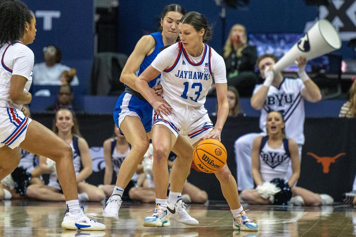 Kansas Jayhawks guard Holly Kersgieter (13) dribbles in the first half of a Big 12 Tournament women’s basketball game against the BYU Cougars at T-Mobile Center on Friday, March 8, 2024, in Kansas City.