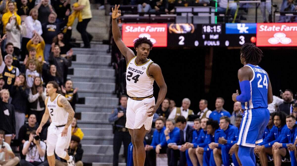 Missouri’s Kobe Brown, center, celebrates a three-pointer in front of Kentucky’s Chris Livingston, right, during Wednesday night’s game in Columbia, Mo.