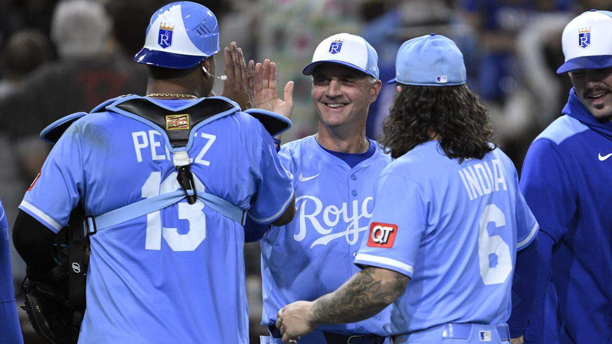 Manager Matt Quatraro (C) of the Kansas City Royals celebrates with Salvador Perez #13 and Jonathan India #6 after defeating the San Diego Padres 6-5 at Petco Park on June 20, 2025 in San Diego, California.