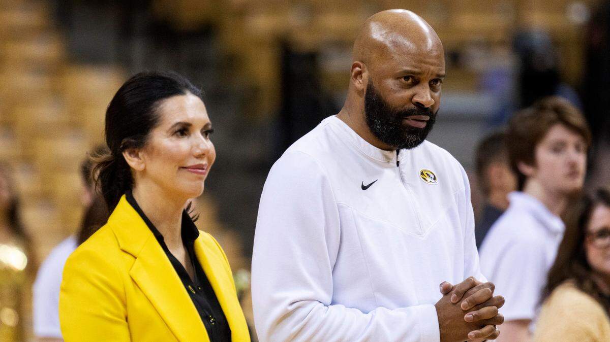 Missouri head coach Cuonzo Martin, right, and athletic director Desiree Reed-Francois, left, greet seniors before the last home NCAA college basketball game against Georgia Saturday, March 5, 2022, in Columbia, Mo. (AP Photo/L.G. Patterson)