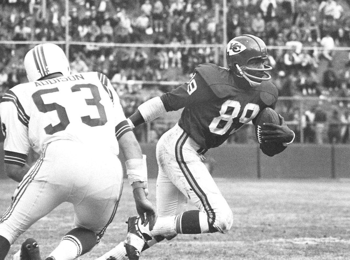 Wide receiver Otis Taylor of the Kansas City Chiefs runs with the ball after catching a pass against the Patriots on Sunday, Nov. 23, 1966 in Kansas City. The Chiefs and Pats tied 27-all that day.