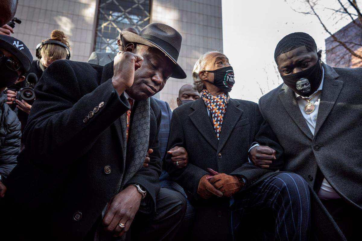 Attorney Ben Crump, left, the Rev. Al Sharpton, second from left, and Brandon Williams, nephew of George Floyd, take a knee for 8 minutes and 46 seconds during a news conference Monday at the Hennepin County Government Center in Minneapolis, Minnesota. Monday was the first day of the murder trial for former Minneapolis police officer Derek Chauvin who is charged with killing George Floyd while making an arrest last year.. Eight minutes and 46 seconds is the time Chauvin had his knee on Floyd’s neck before he died.