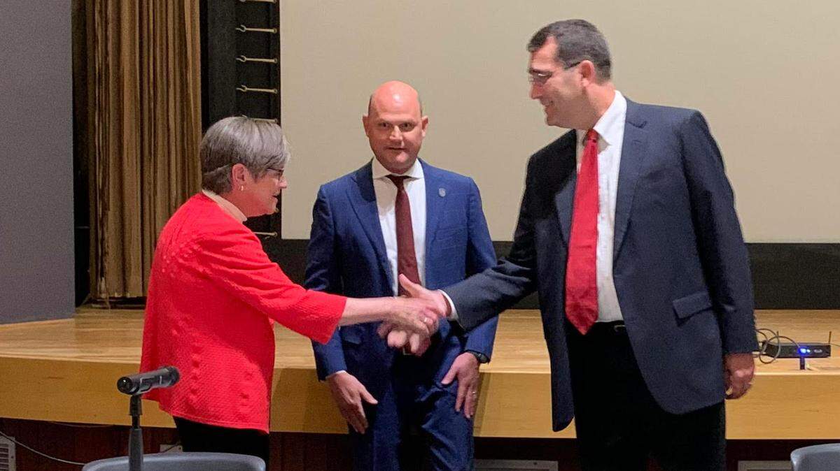 Kansas Gov. Laura Kelly and state Attorney General Derek Schmidt shake hands before the State Board of Canvassers meeting to certify the results of the Aug. 2 election. Kelly and Schmidt will face each other on the Nov. 8 ballot.