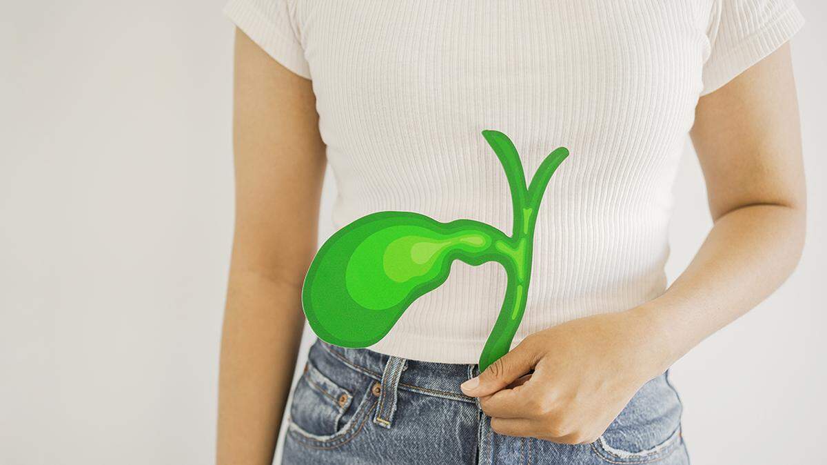 Hands holding bile duct paper cutout, bile duct obstruction, world Cholangiocarcinoma day concept