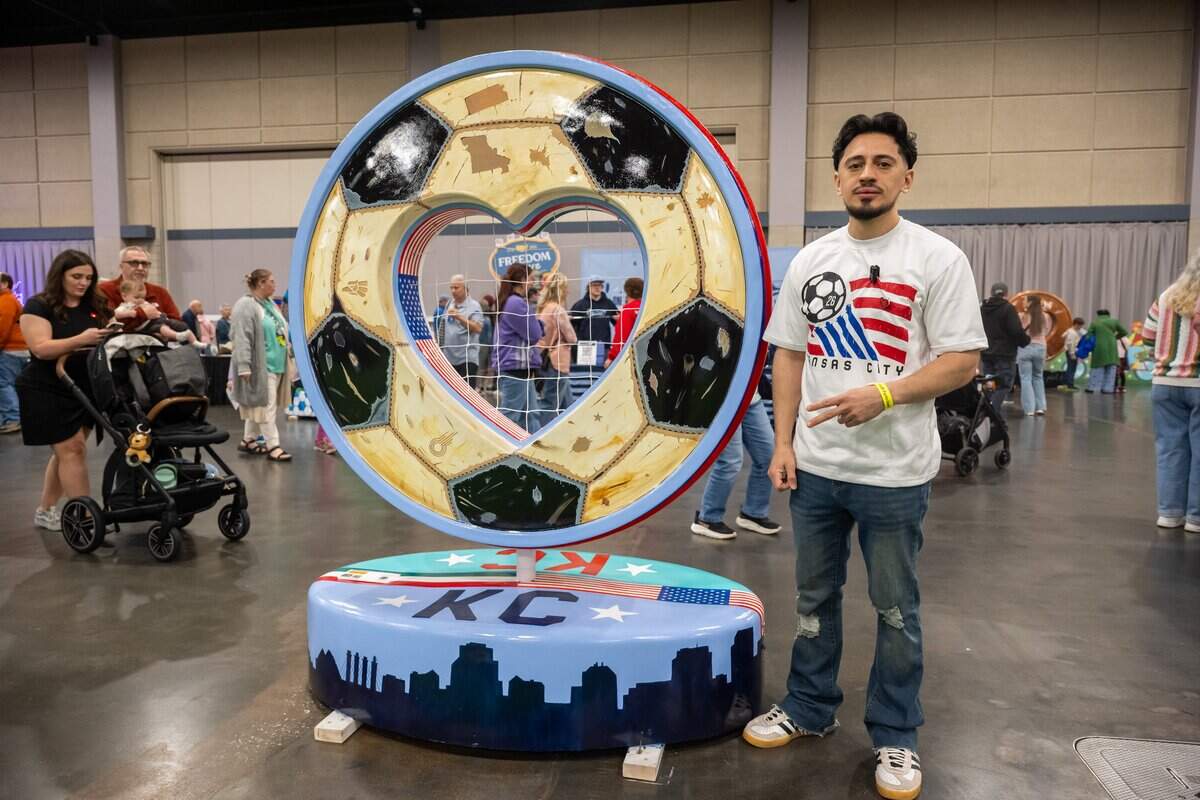Artist Daniel Heredia stands next to his heart titled “Soccer Unites” during the first public exhibition of the new hearts titled “150 United,” on Saturday, April 4, 2026, in Overland Park. Heredia was one of several artists that chose to highlight soccer with their designs.