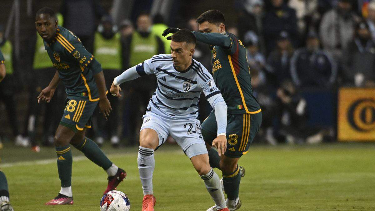 Los Angeles Galaxy midfielder Marco Delgado (8) pressures Sporting Kansas City midfielder Erik Thommy (26) during the first half at Children’s Mercy Park on March 11, 2023.