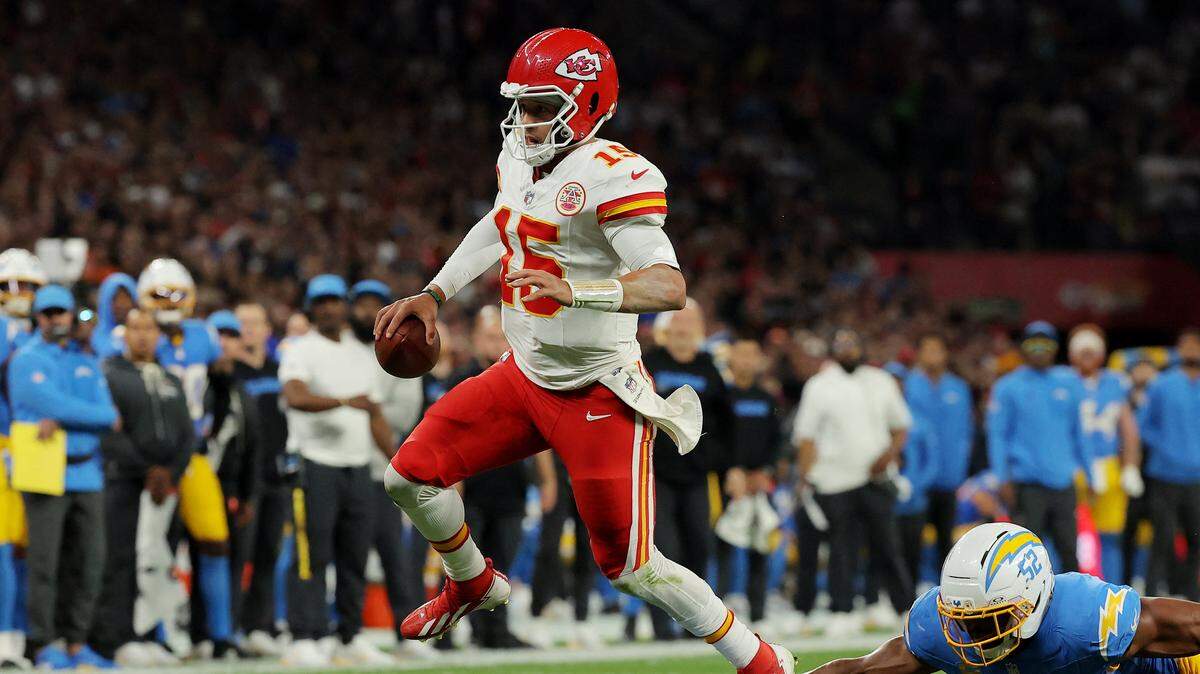 Kansas City Chiefs quarterback Patrick Mahomes eludes Los Angeles Chargers linebacker Khalil Mack during the teams’ NFL season-opening game at Corinthians Arena in Sao Paulo, Brazil, on Friday, Sept. 5, 2025.