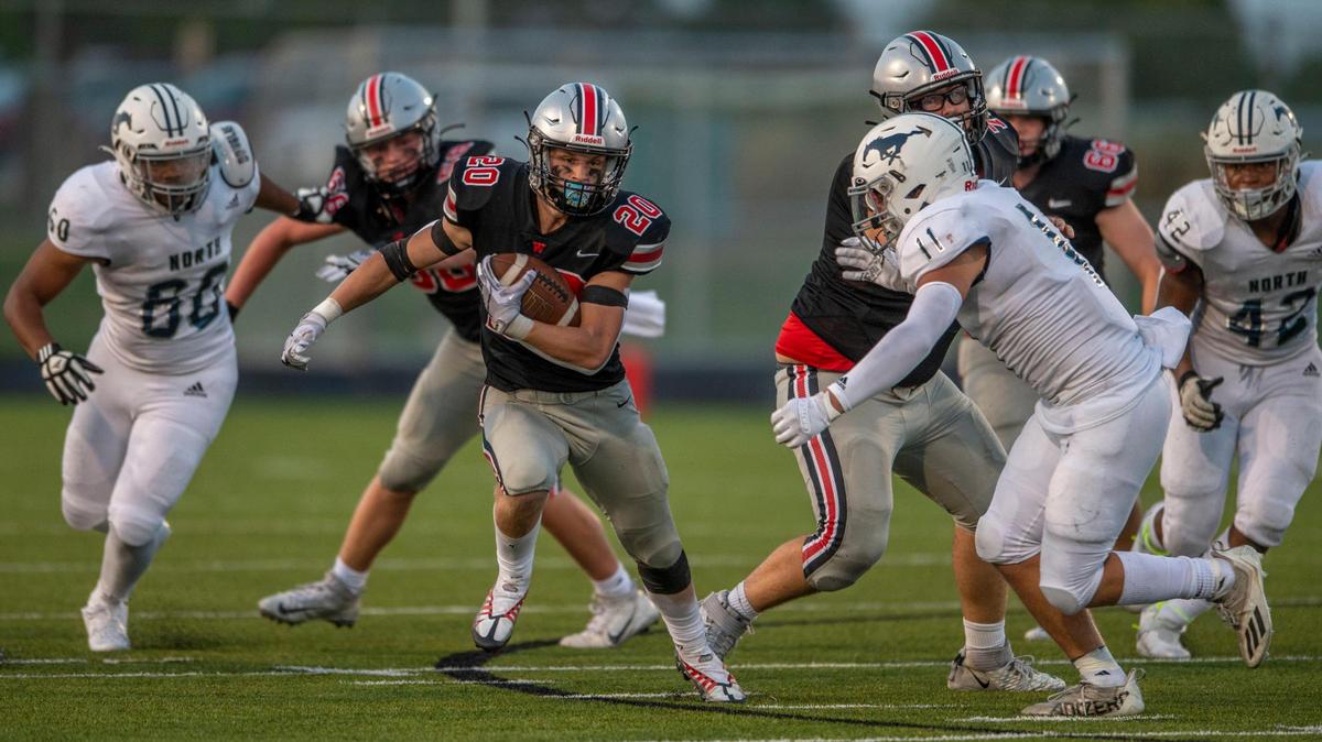 Blue Valley West Jaguars running back Sage Huffman, center, runs for yardage against the Blue Valley North Mustangs Friday night at Blue Valley West Stadium.