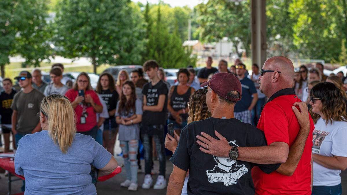 Andy Burris, left, is embraced by his friend Mark Mahon during a rally against fentanyl on Saturday, Sept. 16, 2023, in Leavenworth, Kansas. Burris founded his organization The Cruz4Life Foundation after his son Cruz Burris died from a fentanyl overdose in Jan. 2023.