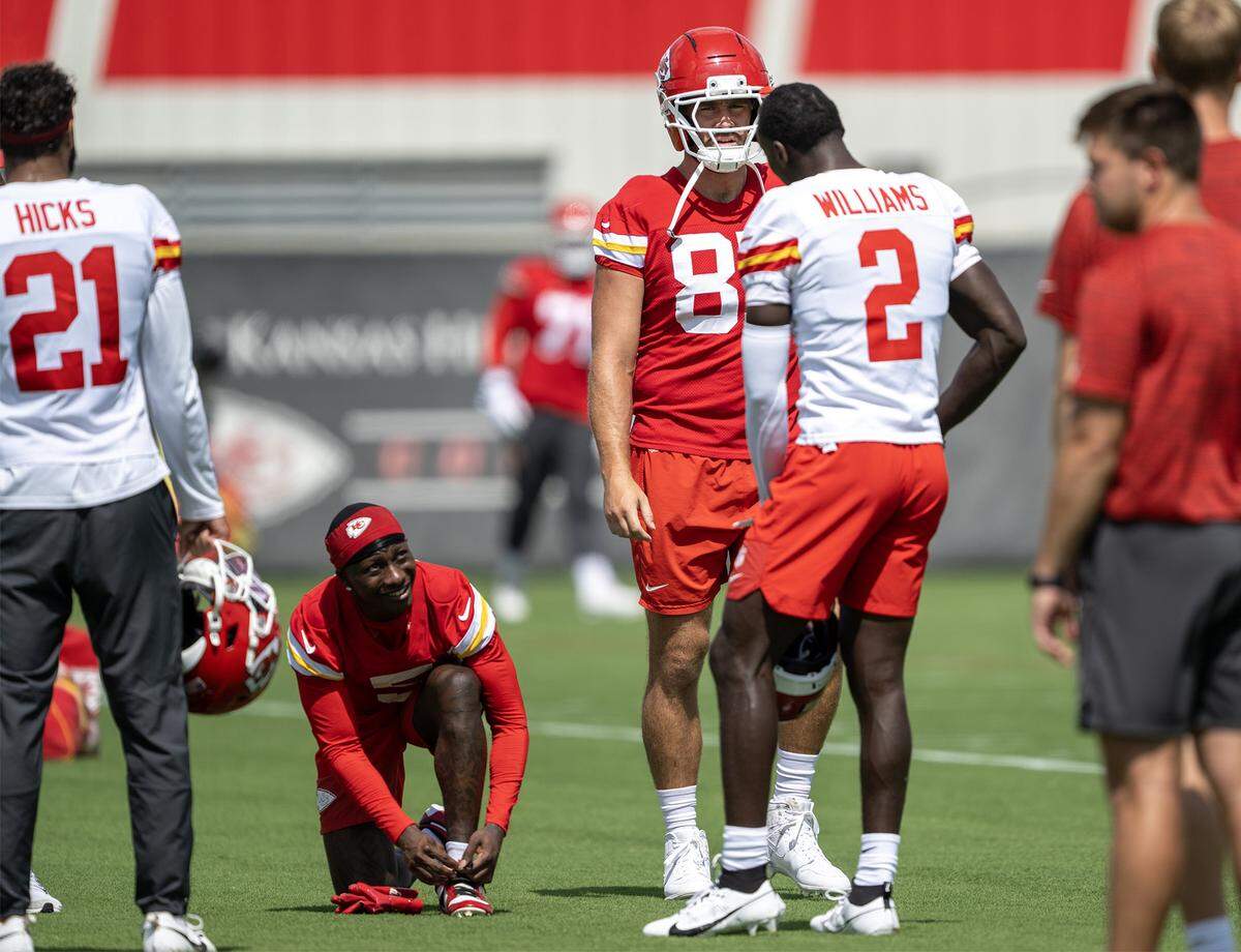 Kansas City Chiefs tight end Travis Kelce (87) talks with cornerback Joshua Williams (2) as they warm up at the team's training facility on Wednesday, August 20, 2025. in Kansas City