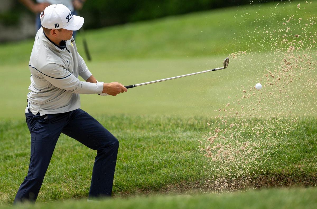 Jeremy Paul of Heidelberg, Germany, blasts out of the bunker on the first hole during the first round of the AdventHealth Championship, a PGA TOUR-sanctioned event on the Korn Ferry Tour on Thursday at Blue Hills Country Club in Kansas City.
