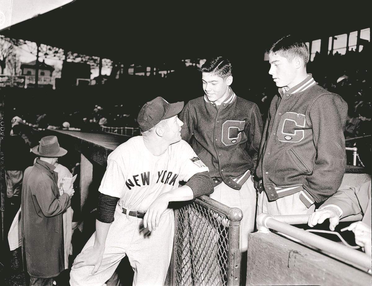 Baseball Hall of Famer Mickey Mantel visits with twin brothers Roy and Ray during a New York Yankees-Kansas City Blues exhibition game at KC’s Municipal Stadium in 1951.