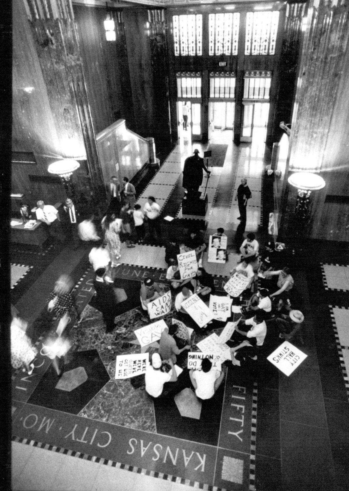 ACT-UP/KC stages a protest in City Hall on July 12, 1990 in support of a human rights ordinance being held up in a City Council committee. The gay activist group briefly disrupted a council meeting with whistles and chants for the ordinance, then left behind cotton balls that had been dipped in skunk oil.