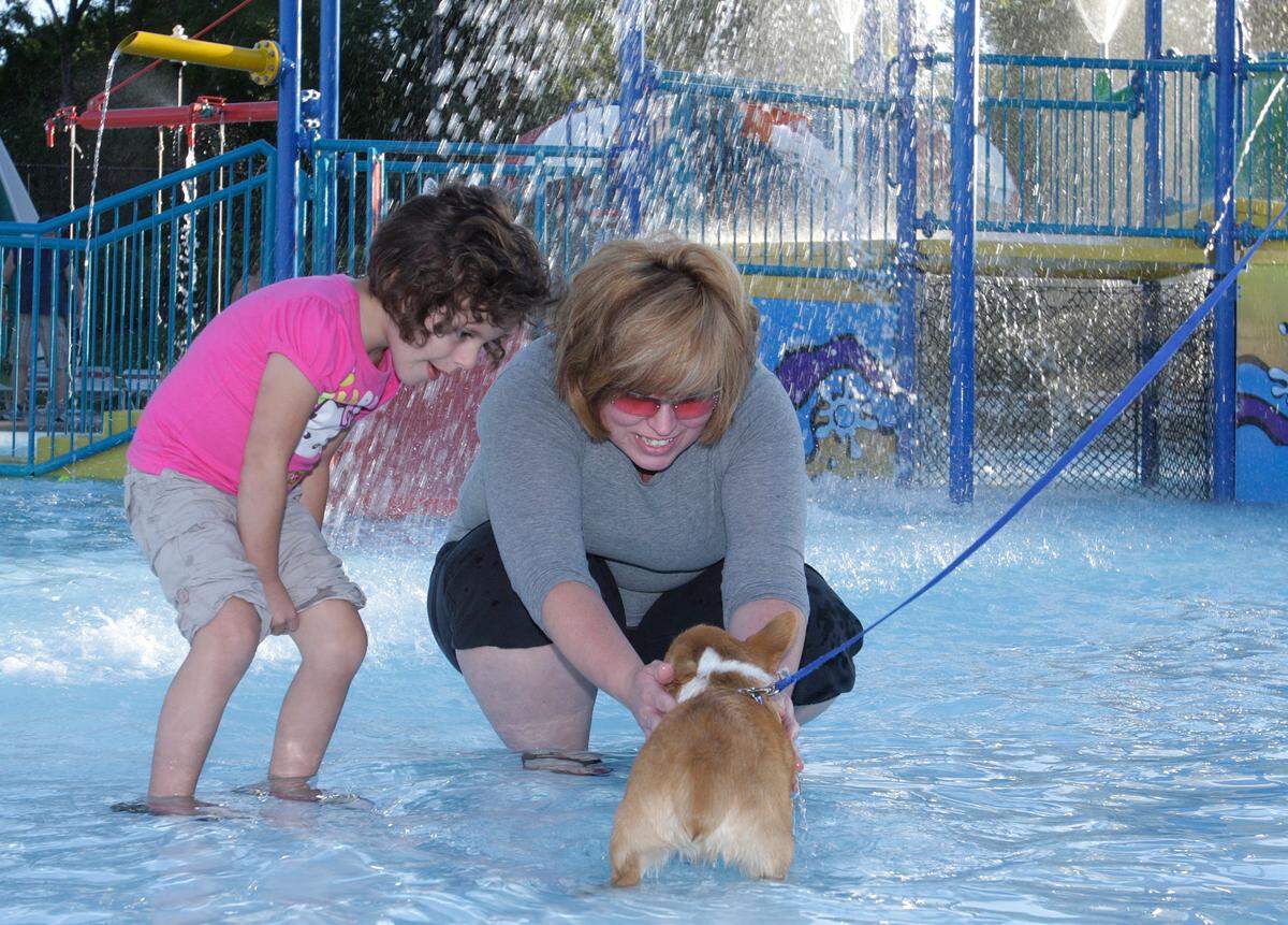 A mother and daughter with their puppy at the 2011 dog swim event at Adventure Oasis in Independence. The water park closed its doors in 2025 after 20 years of operation.